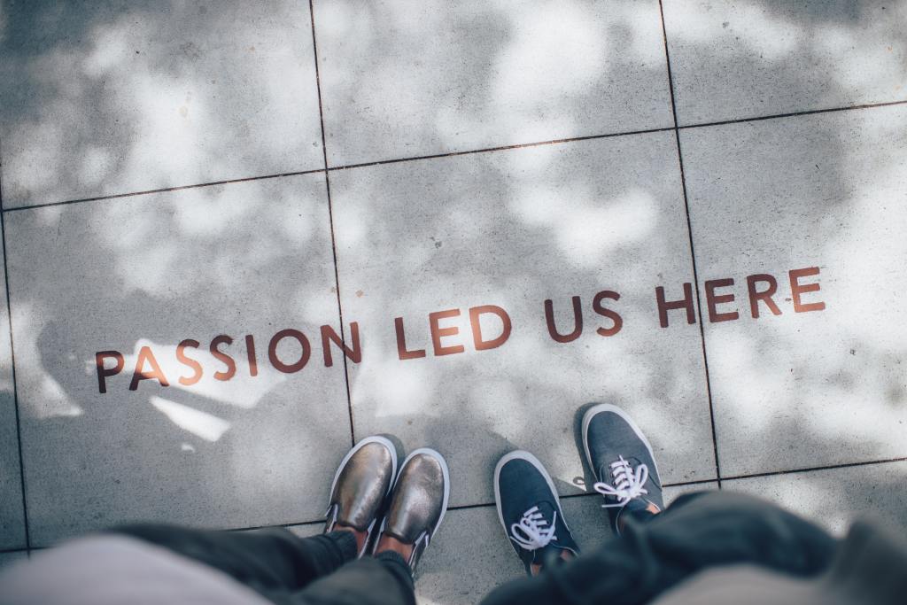 Image of students feet looking down at the message 'Passion led us here'.