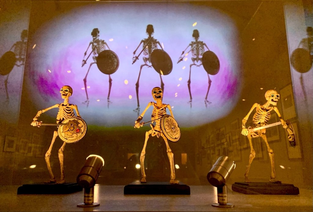 puppet skeletons holding swords and shields on a stage depicting Children of the Hydra's Teeth by David Falkner 