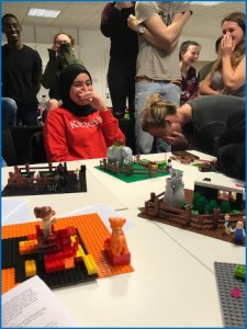 Students learning and laughing through Lego Serious play.