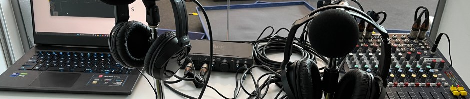 A desk with microphones and headphones ready to record radio