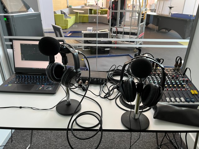 A desk with microphones and headphones ready to record radio